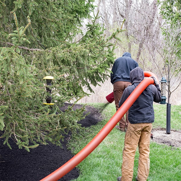 the process of mulch blowing involves using a specialized machine to evenly distribute mulch across a designated area